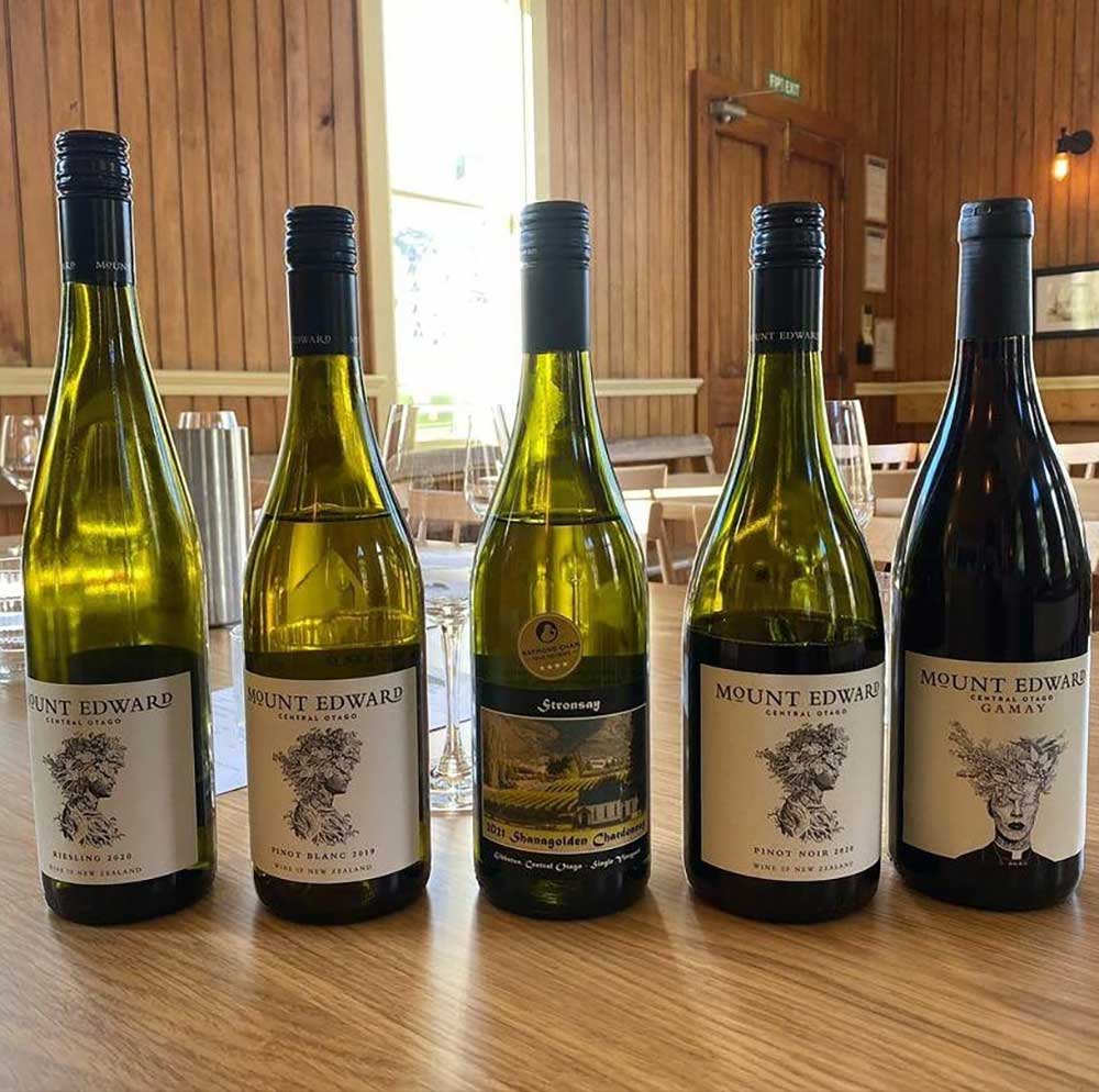 A selection of Mount Edward Wines lined up on a wooden table inside the The Church Cellar Door near Queenstown.