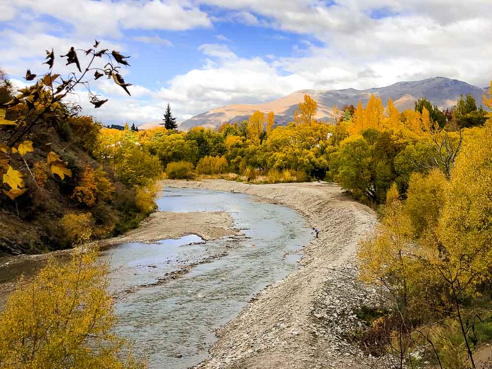 Arrow River Trail in Arrowtown surrounded by trees covered in yellow and golden tones of fall.