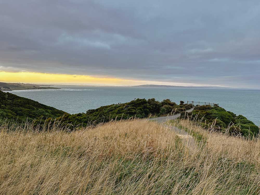 Coastal view of the blue sea on a clear evening at sunset along the southern scenic route in New Zealand 