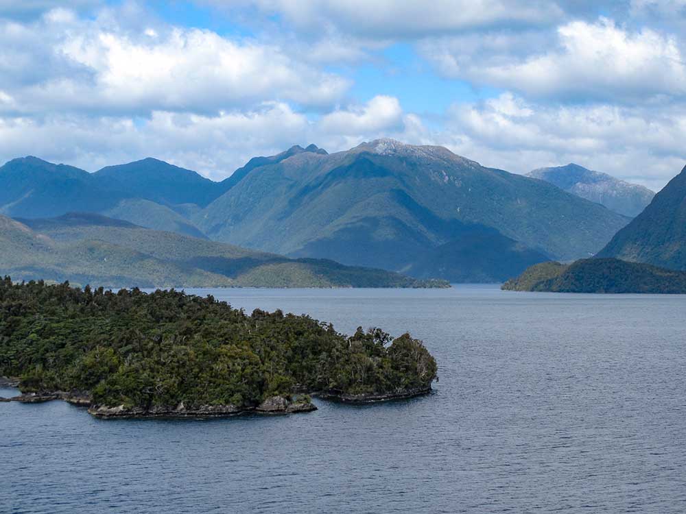 Forest covered mountains and islands in Dusky Sound, a fjord located in New Zealand's South Island.