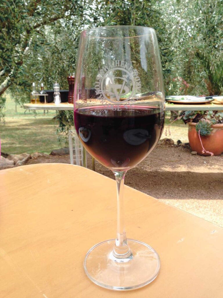 close up of a glass of red wine at one of Auckland's Waiheke Island vineyards.
