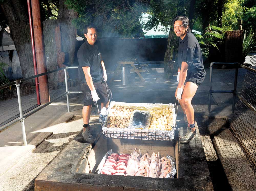 Preparing a hangi feast in Mitai Maori Village in Rotorua