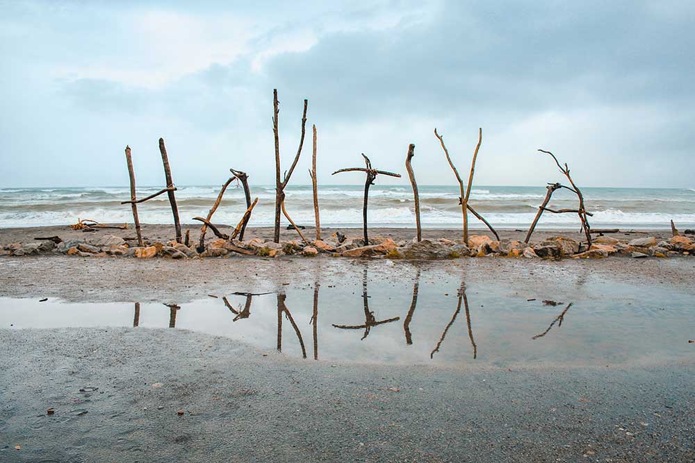 Hokitika sign made of driftwood displayed along Hokitika Beach on the West Coast of New Zealand's South Island. 