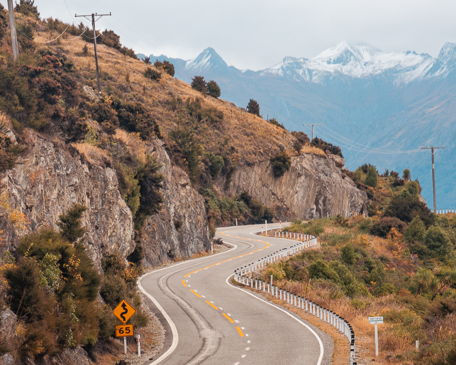 Winding road alongside Lake Hawea in New Zealand.