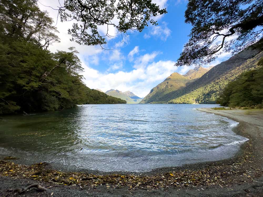 lake surrounded by green mountains