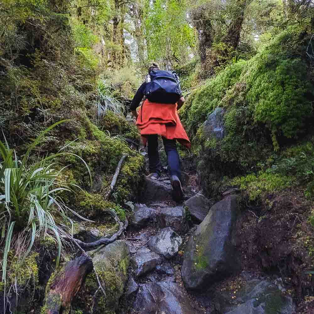 girl walking up a stone path on the Lake marian track