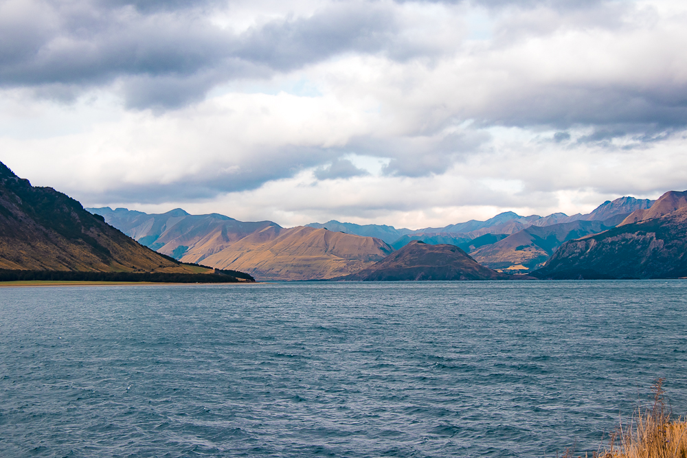 view over lake wakatipu in Queenstown with mountains in the background.
