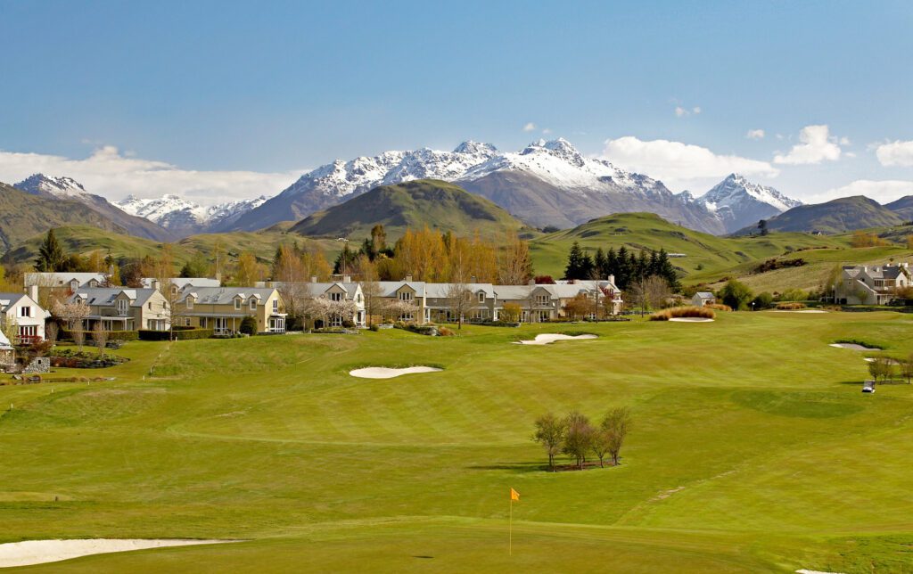 The green fairway of Millbrook Golf Resort surrounded by snow capped mountains.