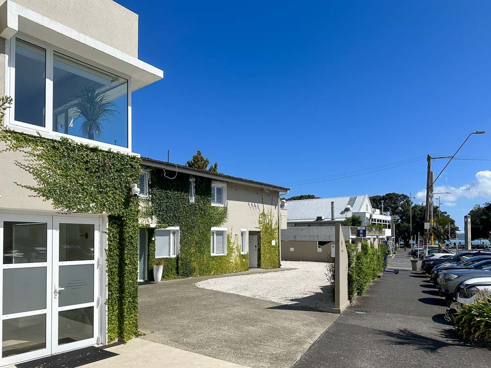 Exterior of the Coastal Apartments in Mission Bay Auckland looking down the street on a clear day.