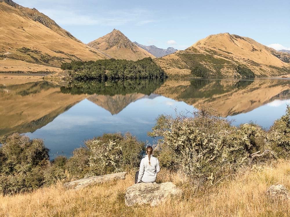 reflections of the mountains in moke lake near queenstown