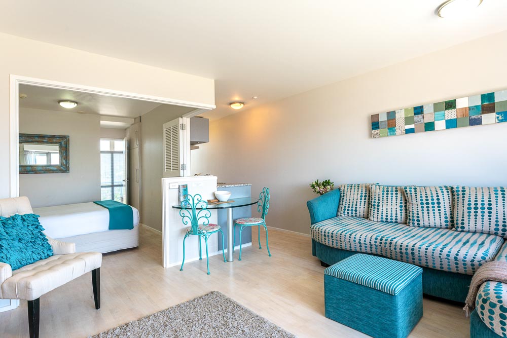 The interior of Oneroa Bay Villas on Waiheke Island, simply decorated in cream and blue colors.
