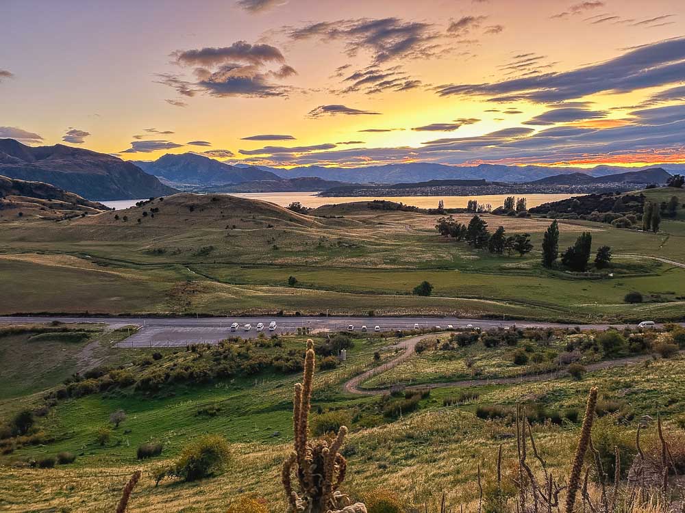 sunrise over Lake Wanaka in the distance.