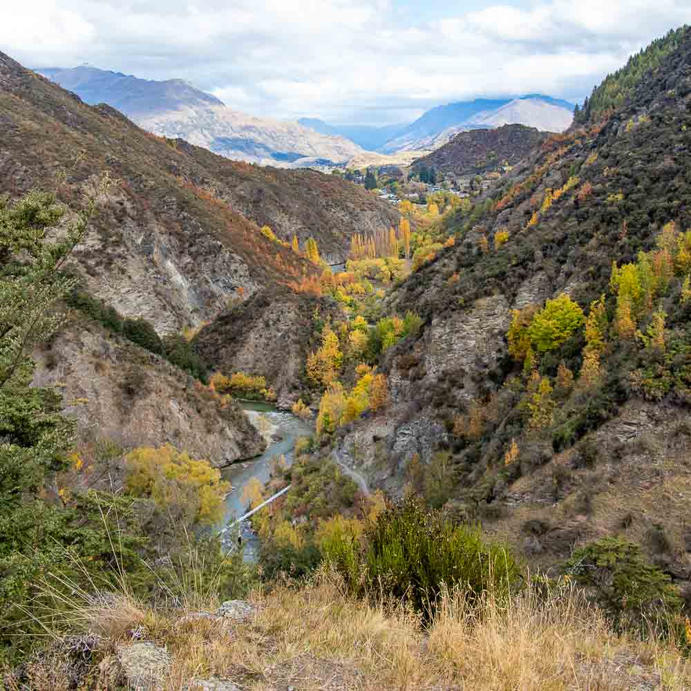 Stunning views over valley filled with autumn colours of red, yellow and orange