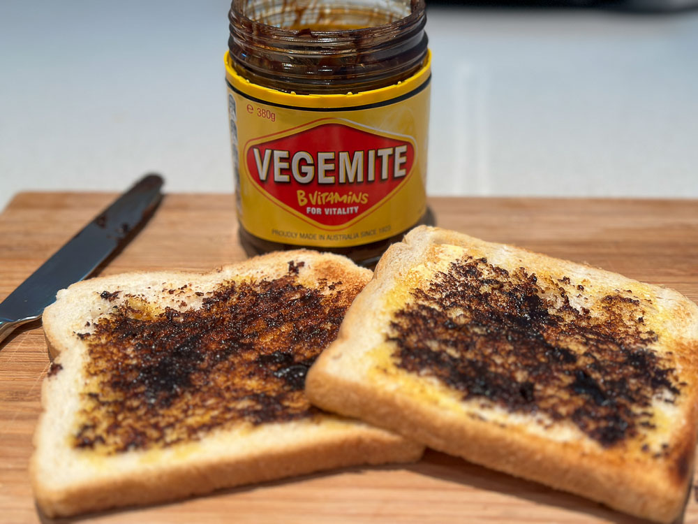 Jar of marmite with two pieces of toast